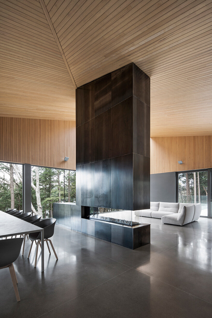 naturehumaine tops lake house in canada with sculptural slanted roofs + polygonal skylights