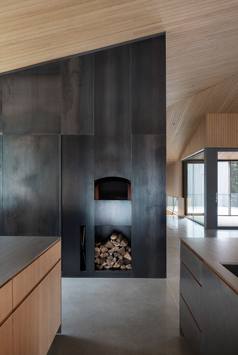 naturehumaine tops lake house in canada with sculptural slanted roofs + polygonal skylights