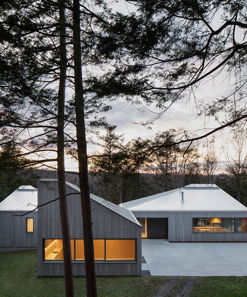 naturehumaine tops lake house in canada with sculptural slanted roofs + polygonal skylights