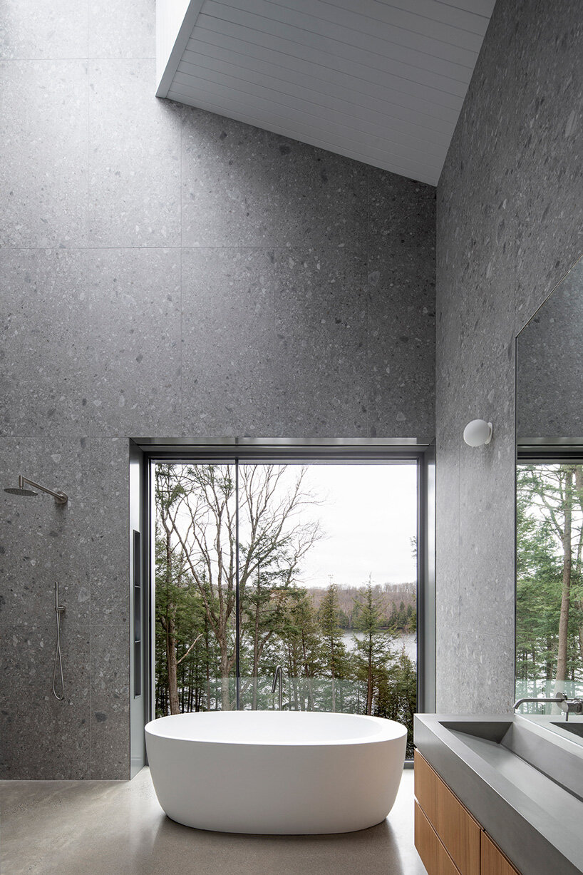 naturehumaine tops lake house in canada with sculptural slanted roofs + polygonal skylights