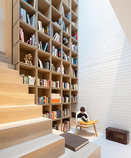 monumental double-height library decorates this renovated mid-century home
