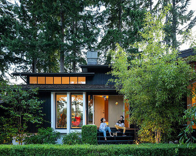 monumental double-height library decorates this renovated mid-century home