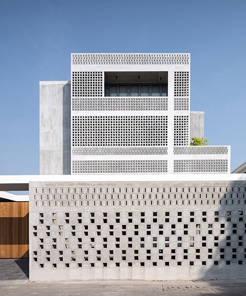 perforated brick facade + massive climbing wall adorn this house in thailand