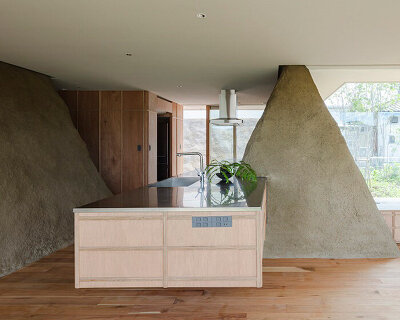 ADX transforms excavated soil into trapezoid walls for this house in japan