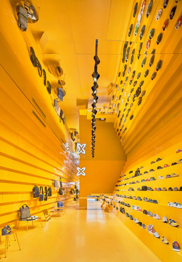 studio animal steps bright yellow walls for clothing store in malaga, spain