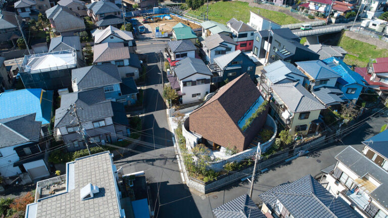 two concrete curves frame suppose design office's shingle-clad house in ...