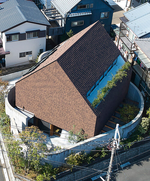 two concrete curves frame suppose design office's shingle-clad house in japan