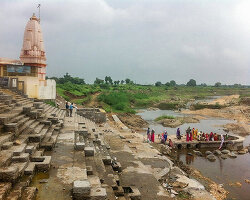 stone platform in temple reconstruction leads devotees towards the moran river in india