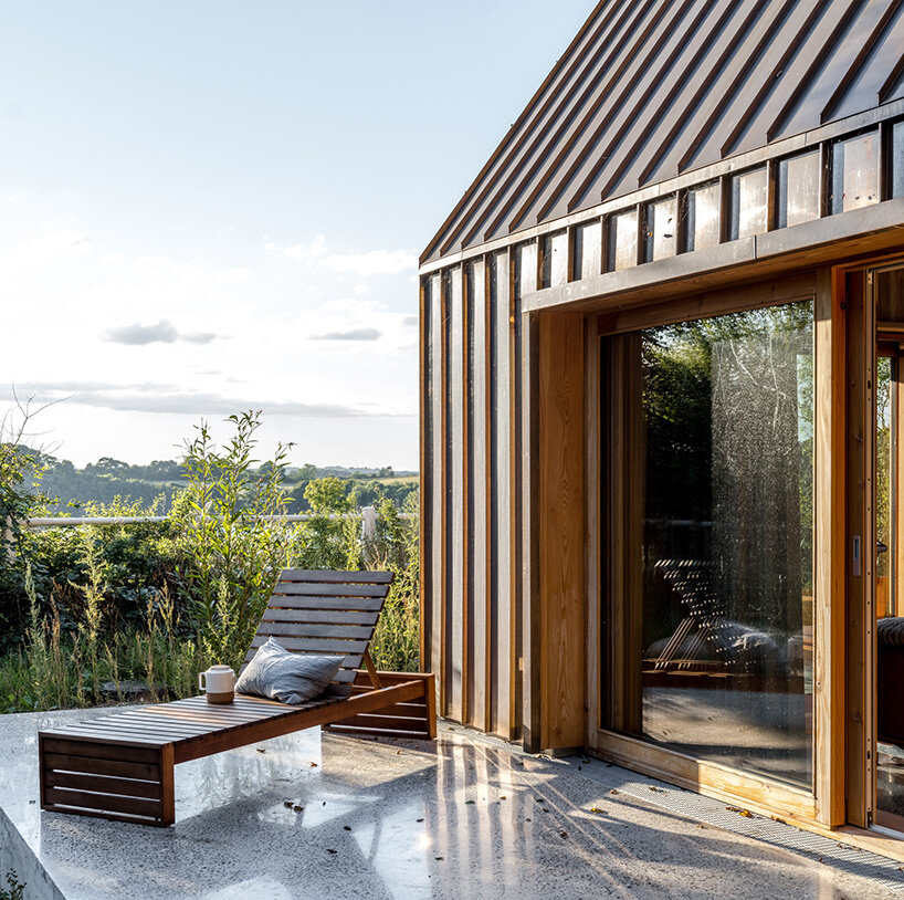 SLETH inserts copper-clad getaway cabin into danish forest