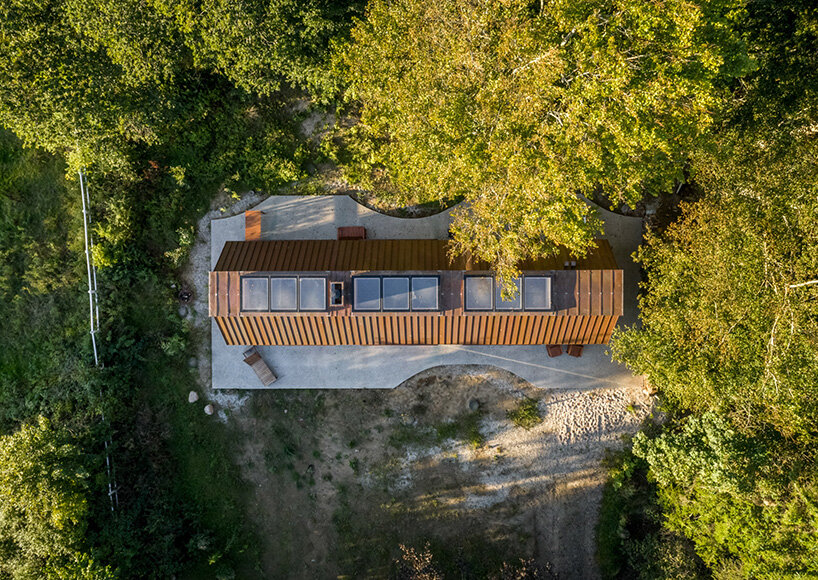 SLETH inserts copper-clad getaway cabin into danish forest