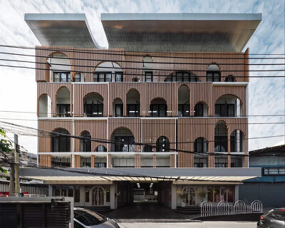 wooden arches cover a renovated building in bangkok like a huge piece of fabric