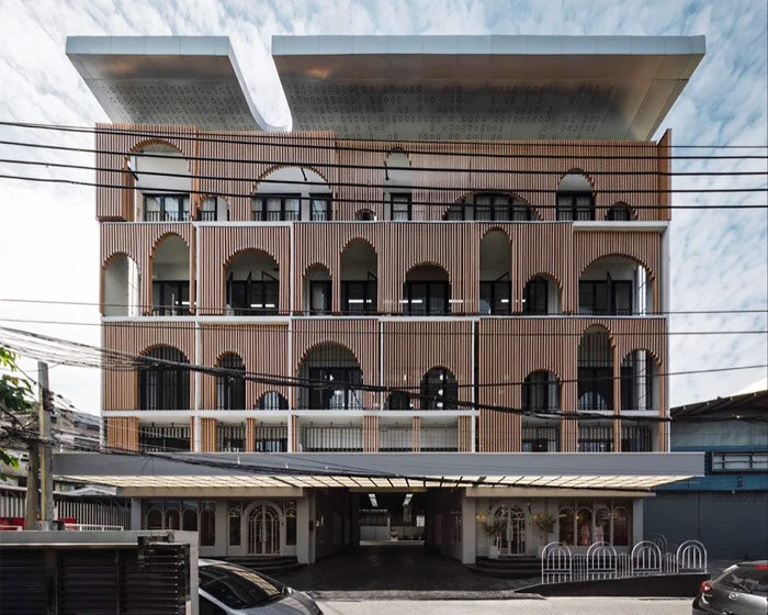 wooden arches cover a renovated building in bangkok like a huge piece of fabric
