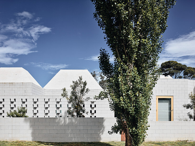 concrete masonry blocks + frustum roofs animate the façade of this beach house by architects EAT