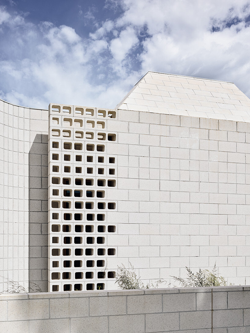 concrete masonry blocks + frustum roofs animate the façade of this beach house by architects EAT