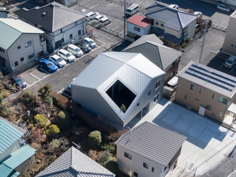 roof cut out reveals secluded terrace in this mixed-use building in japan