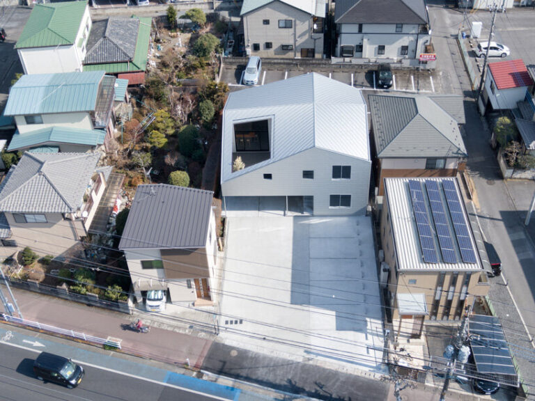 roof cut out reveals secluded terrace in this mixed-use building in japan