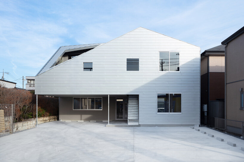 roof cut out reveals secluded terrace in this mixed-use building in japan