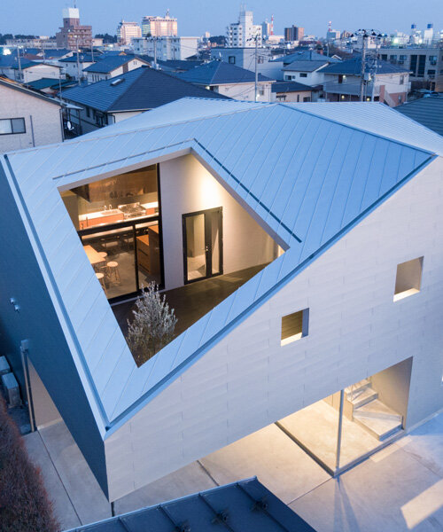 roof cut out reveals secluded terrace in this mixed-use building in japan