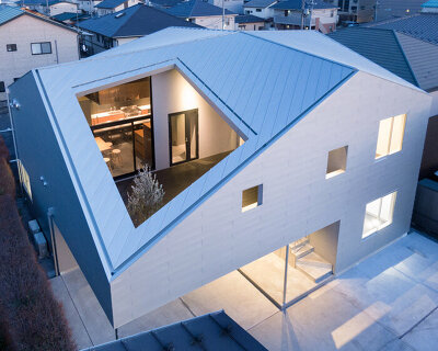 roof cut out reveals secluded terrace in this mixed-use building in japan