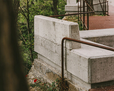 concrete masses, rusted steel + stones blend this promenade into the spanish landscape