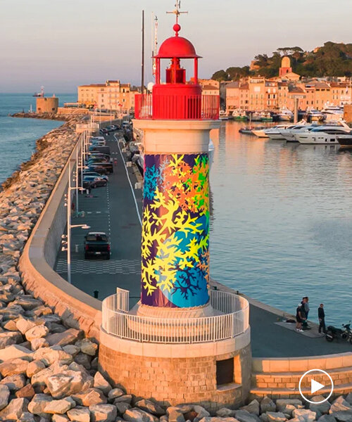 fluorescent corals wrap st tropez's lighthouse to raise awareness of fragile ocean ecosystems