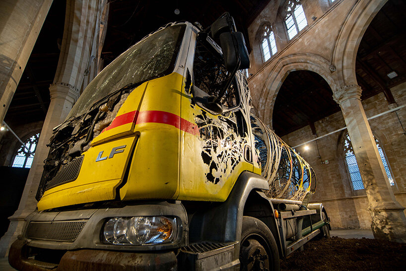 dan rawlings carves a steel forest into a reclaimed oil truck