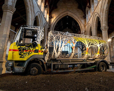 dan rawlings carves a steel forest into a reclaimed oil truck