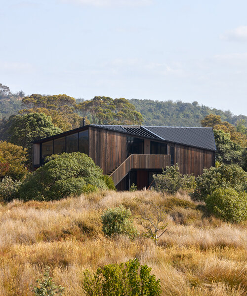 weathered timber clads an angular holiday home in new zealand designed by edwards white