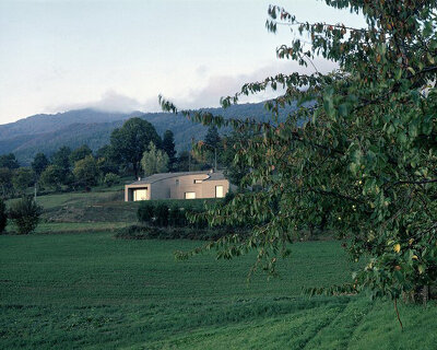 irregular windows disrupt the continuity of this brick-clad house in italy