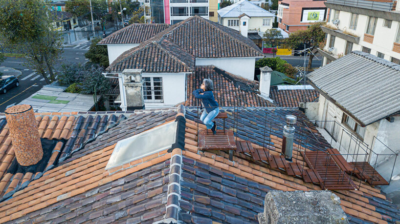 a rooftop observatory by studio 'la cabina de la curiosidad' links to the mountains of quito