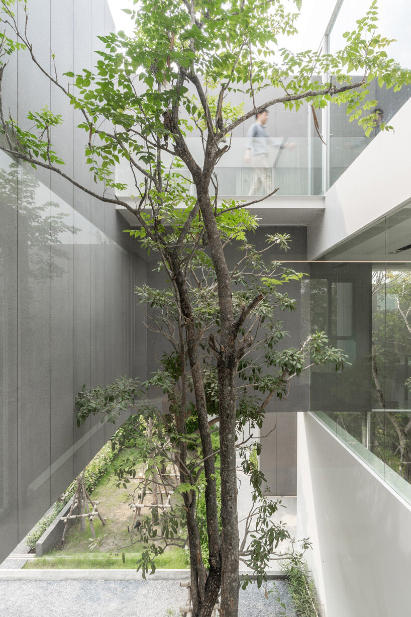 four miniature courtyards bring nature inside this secluded family home in thailand