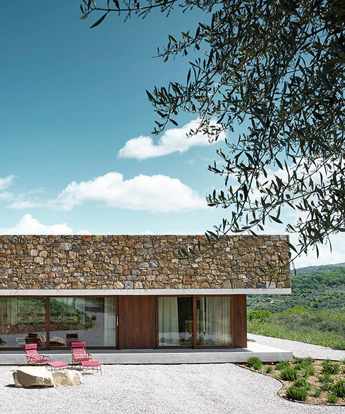 natural stone + wooden infills realize mediterranean house at the foot of mount amiata, italy