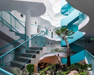 organic balconies + playful pops of blue form environmentally friendly hotel in vietnam