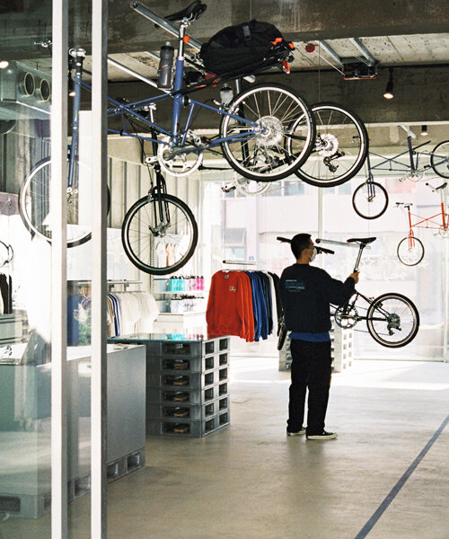 schemata architects integrates movable ceiling racks into korean bike store