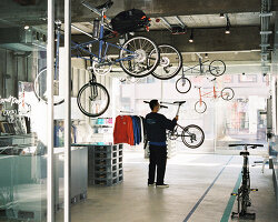 schemata architects integrates movable ceiling racks into korean bike store
