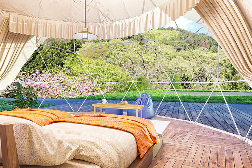 seven dome-like glamping tents emerge from japanese woodland