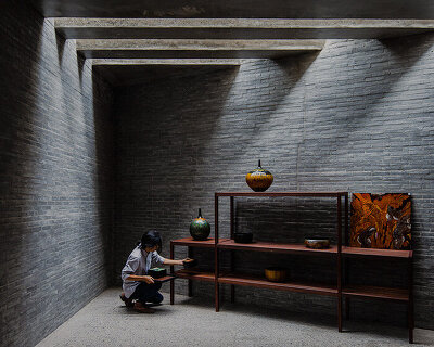solemn shadowplay + exposed roofing highlight lacquerware pieces in vietnamese showroom