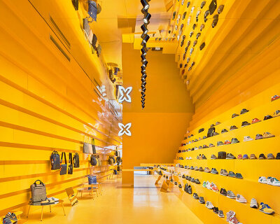stepped yellow walls shape a clothing store in malaga designed by studio animal