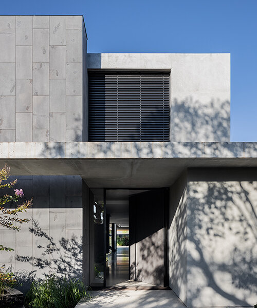 strong symmetrical lines + raw materials dominate concrete residence by the coast of australia