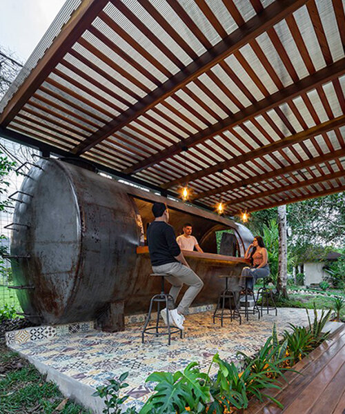 discarded tank is transformed into a rustic bar for outdoor rest pavilion in ecuador