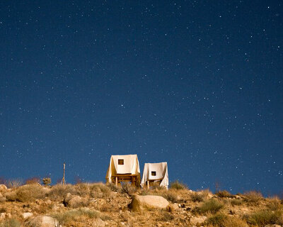 windblown sheets cover 'ghost house' poetic installation by i/thee in california's high desert