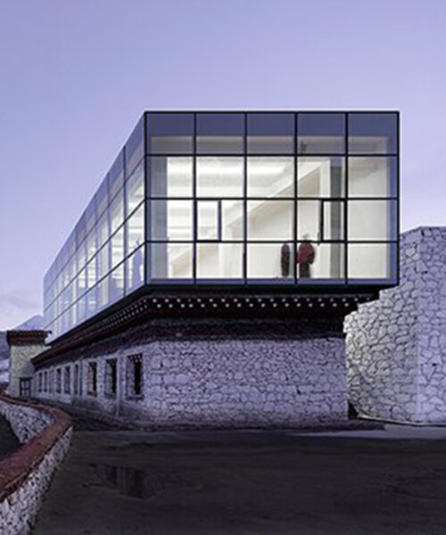glazed rectangular box + white stone walls characterize tsenpo museum extension in china