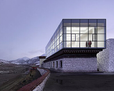 glazed rectangular box + white stone walls characterize tsenpo museum extension in china