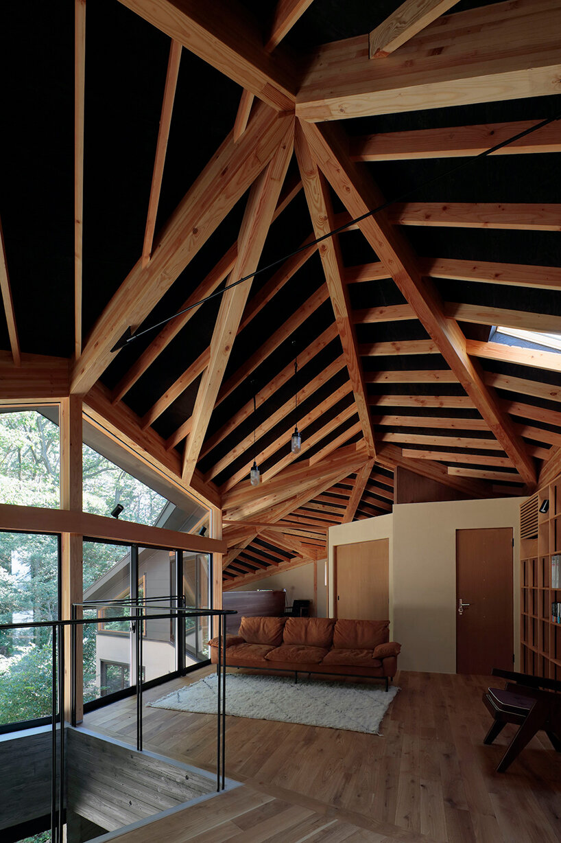 irregular-angled 'phase dance' residence by takeshi hirobe wraps around a large tree in japan