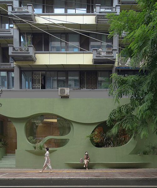 irregular curves bring nature inside this pastel green café in china