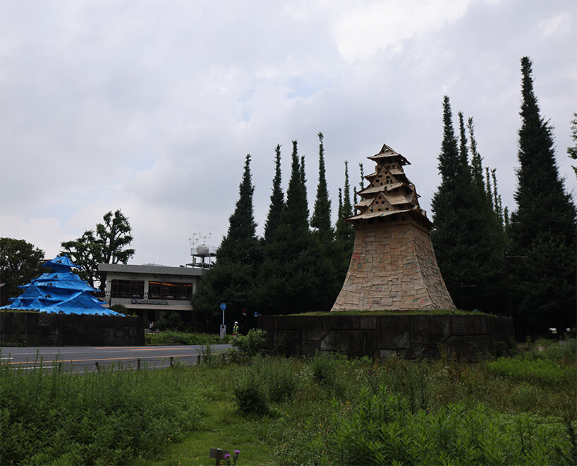cardboard + blue tarp castle by makoto aida stands out in tokyo to emphasize temporariness