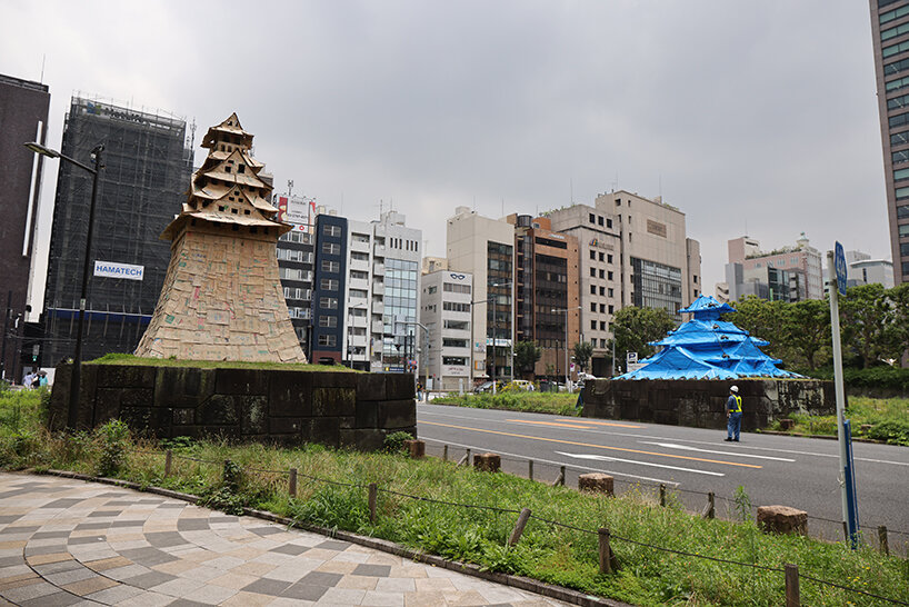 cardboard + blue tarp castle by makoto aida stands out in tokyo to emphasize temporariness