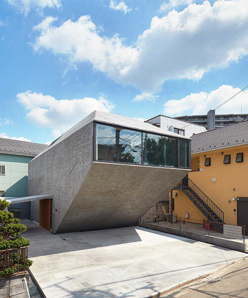 suppose design office builds angular boulder-like house in 