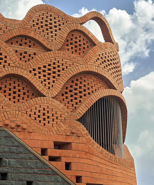 curved red bricks crown a family home in india designed by PMA madhushala