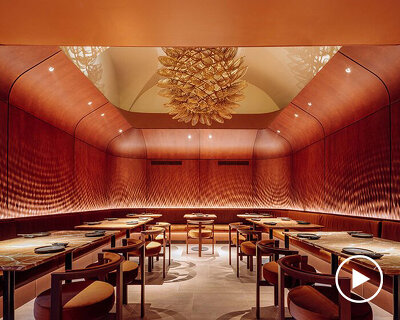 rusty red hues + marmoreal stone complete sculptural 'cocoon room' within lisbon restaurant